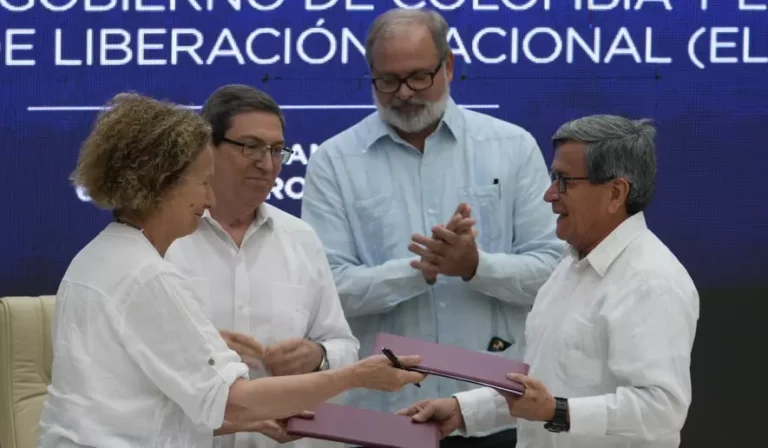 FILE - Colombian government representative Vera Grabe, left, and Colombian commander of the National Liberation Army guerrilla group (ELN) Pablo Beltran exchange their signed ceasefire extension agreement in Havana, Cuba, Feb. 6, 2024.